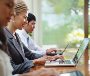 lawyer smiling at laptop while typing