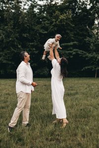 family throwing daughter in the air