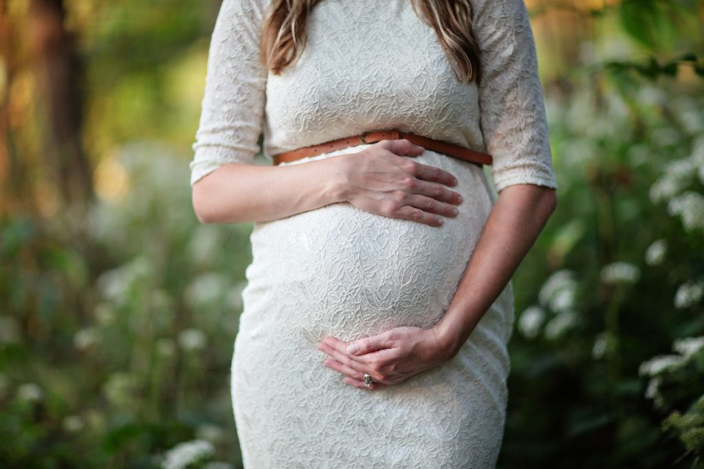 woman holding her pregnant belly