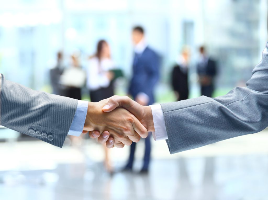 two men shaking hands in suits about sexual harassment case