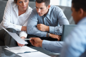 lawyers talking to client on sexual harassment claims